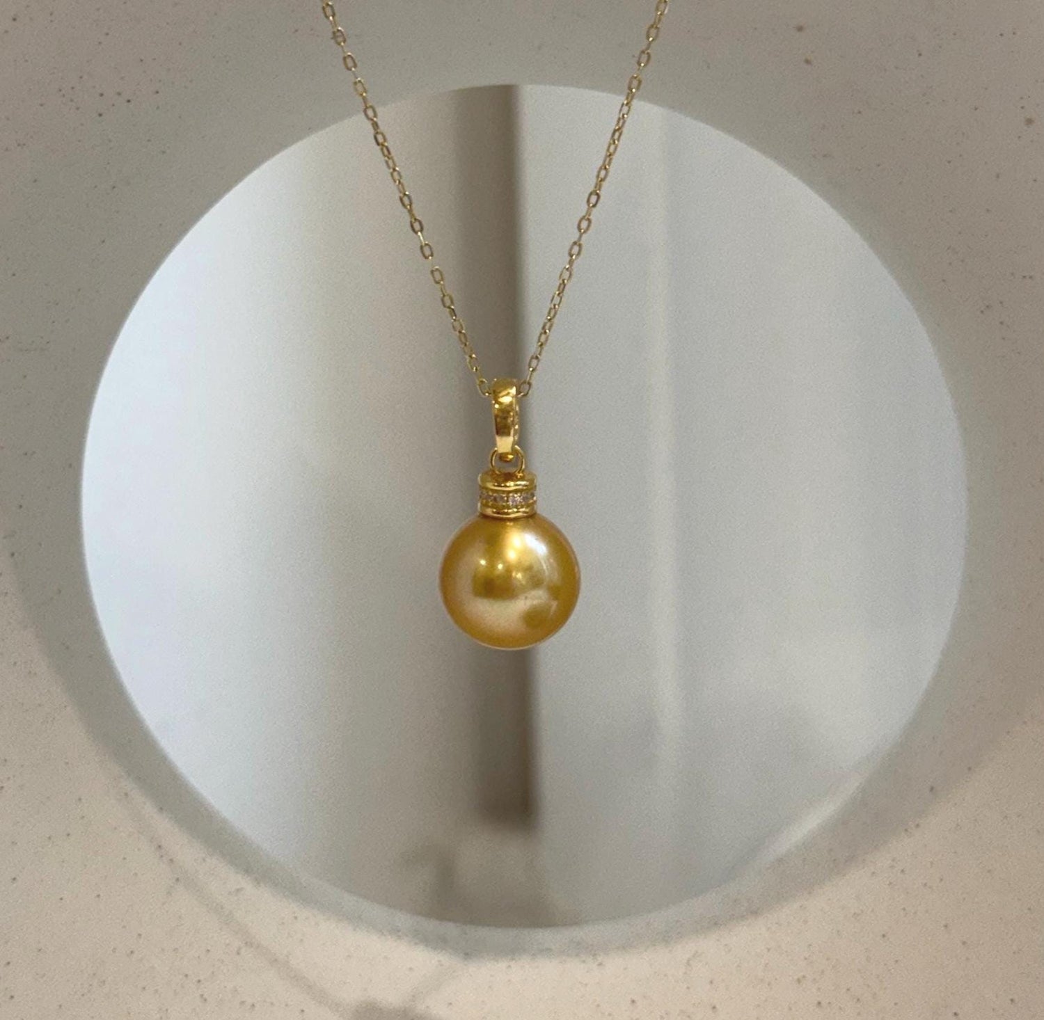 Elly’s 11.4mm Edison deep tea golden freshwater pearl pendant with mirror luster.