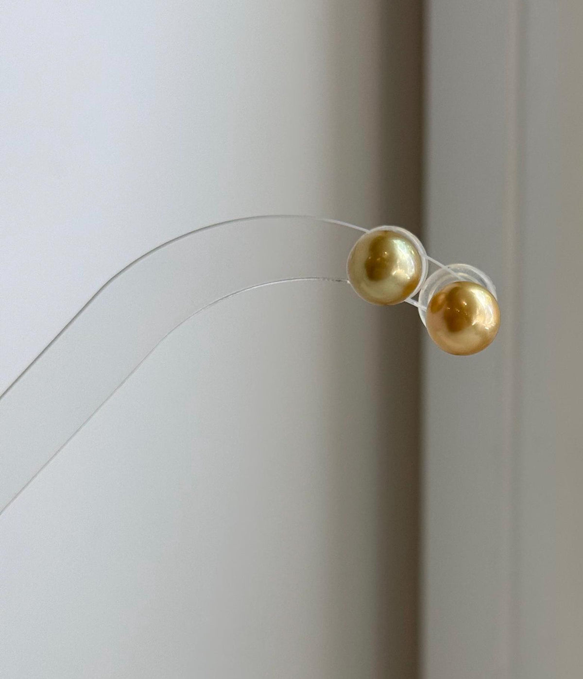 Round 8.8mm golden ocean pearl earrings with extreme mirror luster