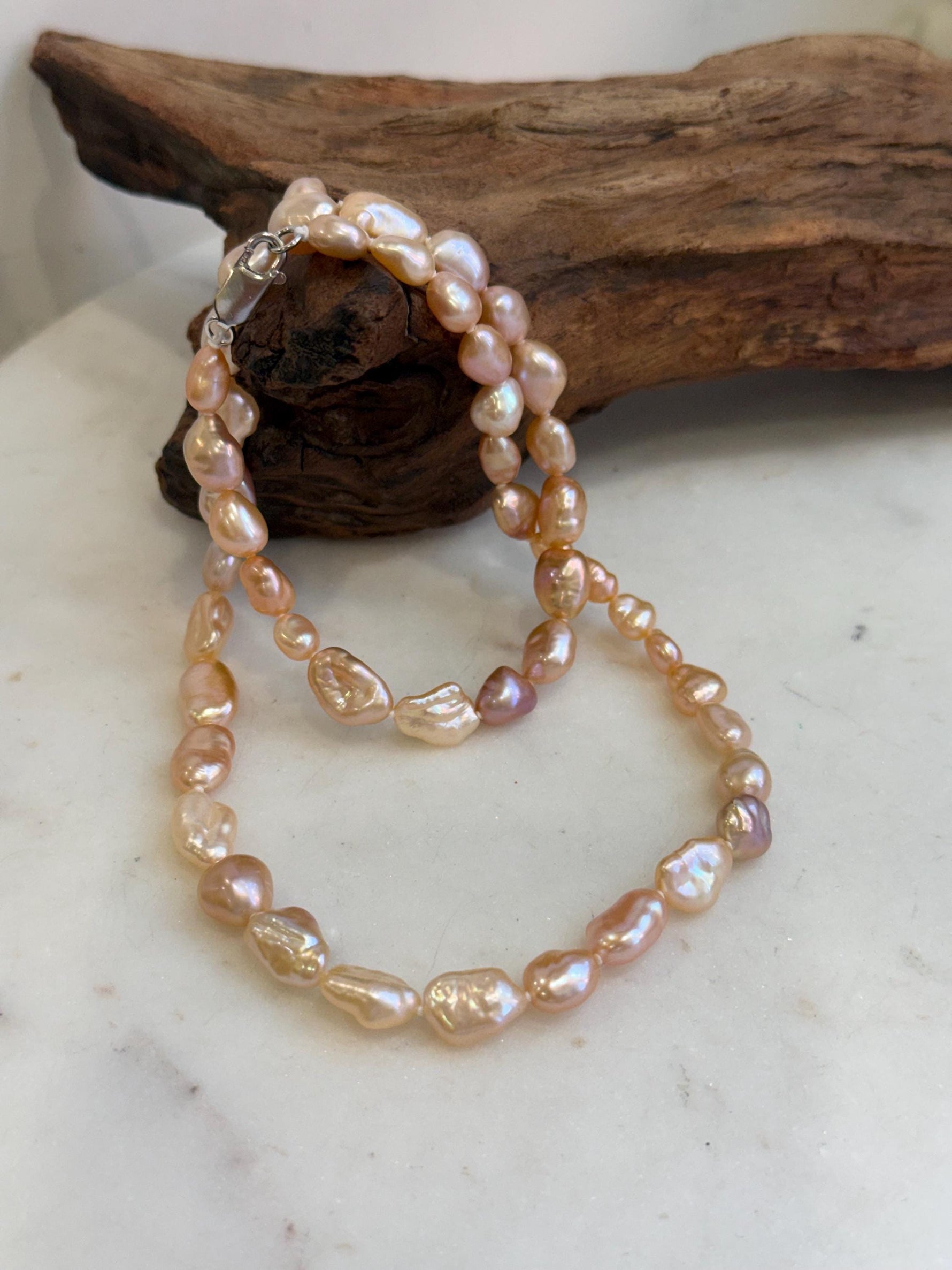 Elegant 19.7 inch Keshi pearl necklace with luminous peach, rose and golden natural tones.