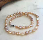 Luxury peach rose gold Keshi pearl necklace with extreme mirror luster and S925 sterling silver finishing.