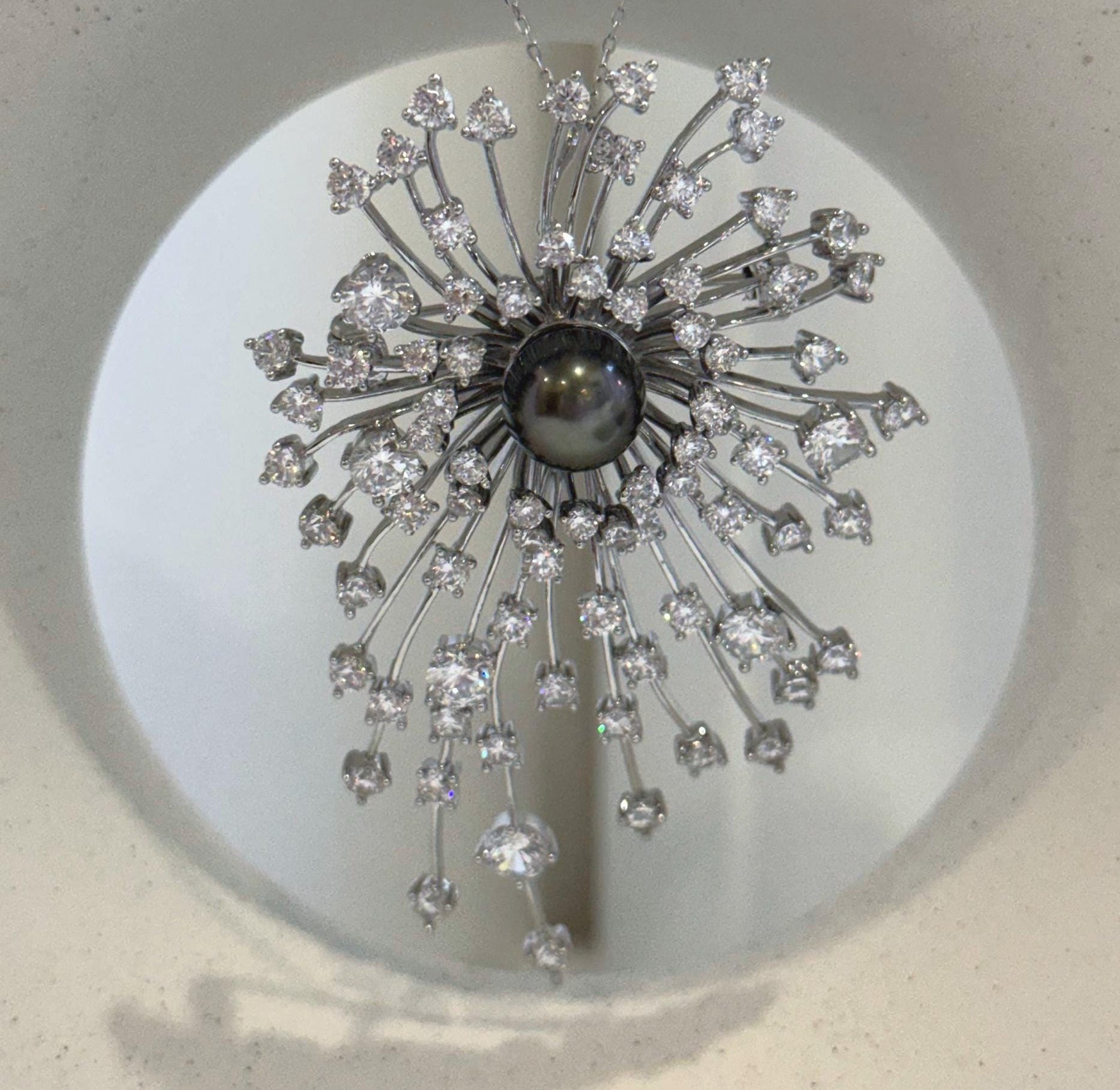 9.3mm platinum black Tahitian pearl set in an elegant statement brooch pendant.