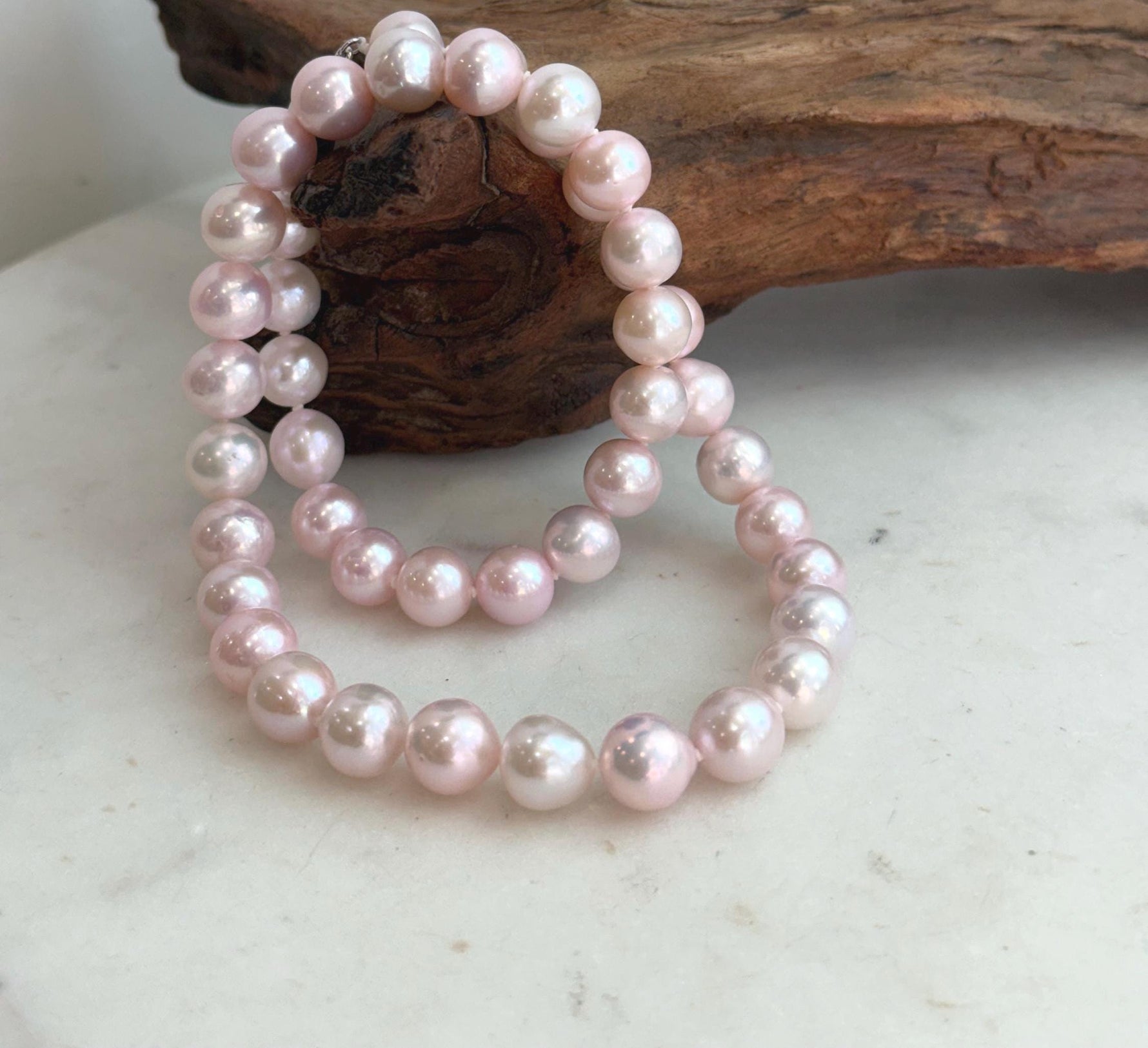 Classic pale pink pearl strand necklace designed for elegant everyday wear and special occasions.