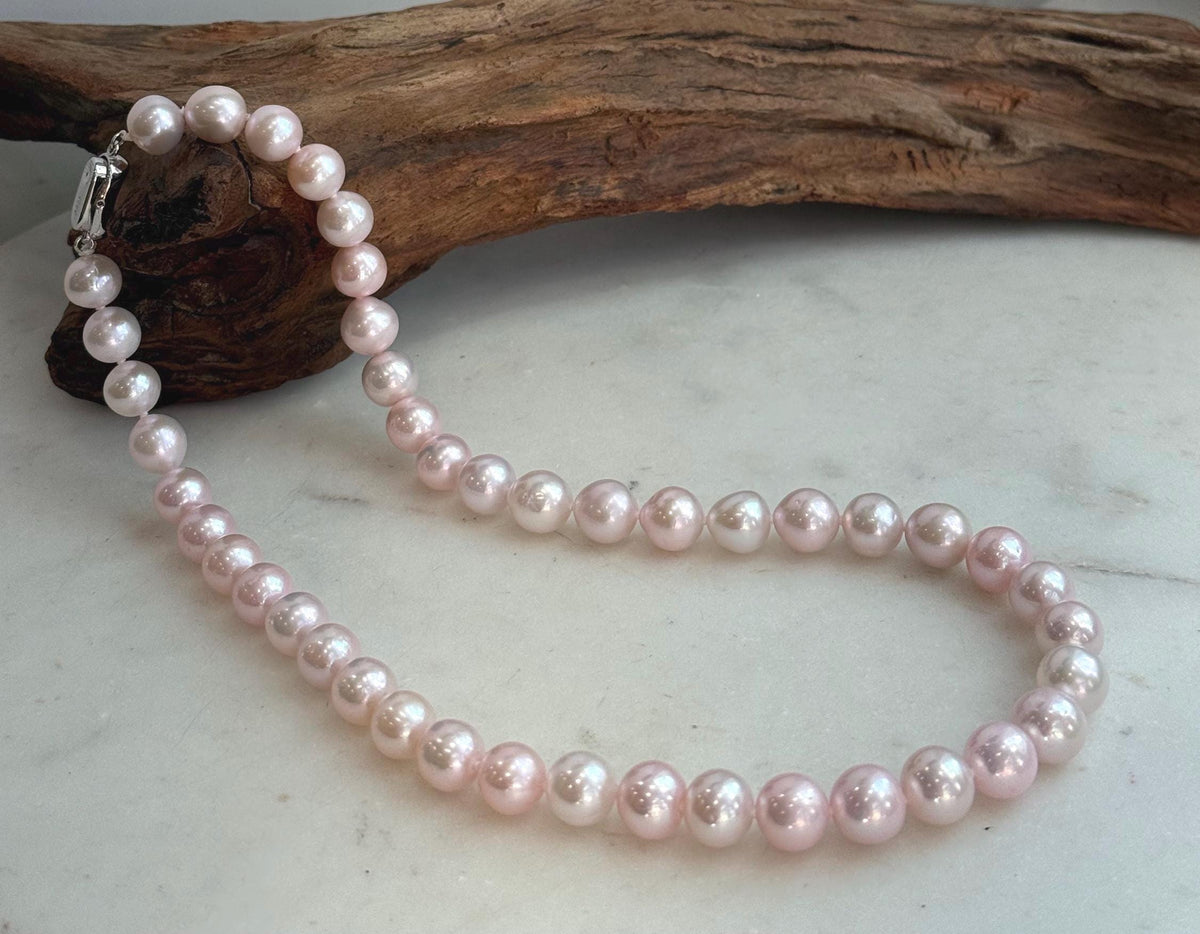 Elegant 17.8-inch genuine pearl necklace with 9–10mm pale pink pearls and extreme mirror luster.