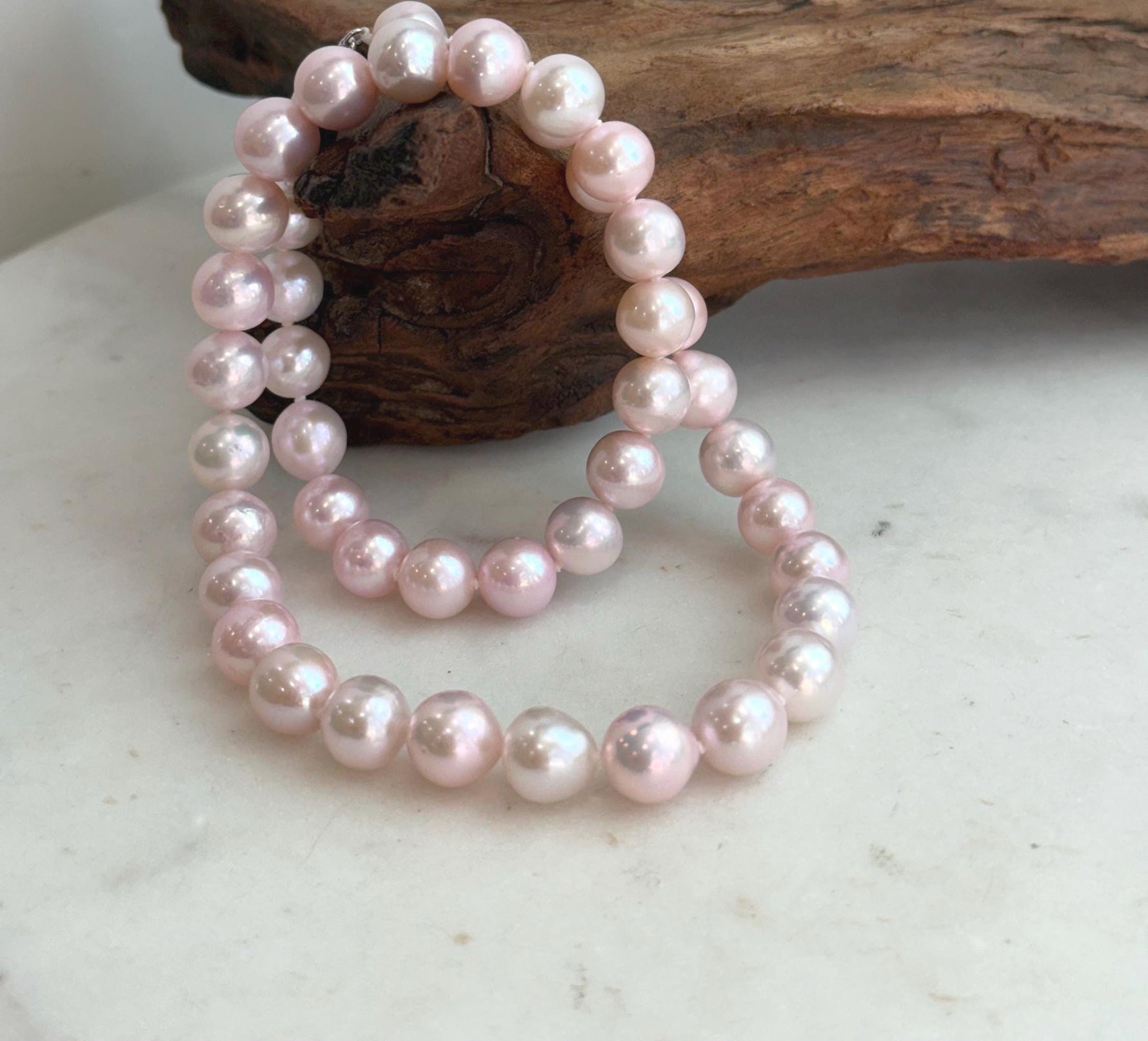 Hand-knotted freshwater pearl necklace with individually secured 9–10mm genuine pearls.