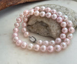Elegant 17.8-inch genuine pearl necklace with 9–10mm pale pink pearls and extreme mirror luster.