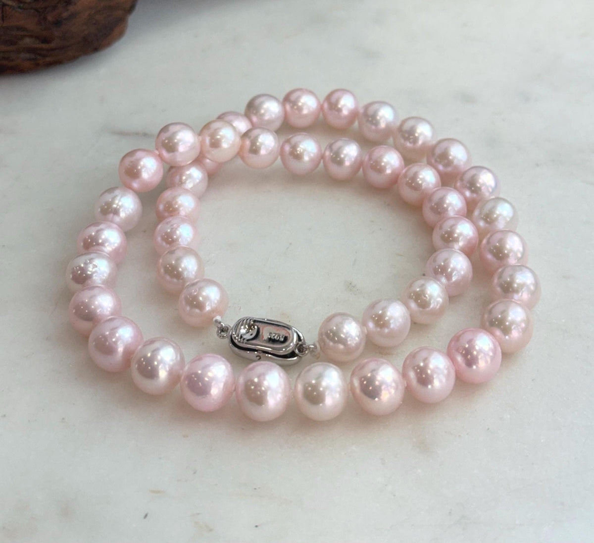 Elegant 17.8-inch pearl necklace hand knotted with 44 luminous freshwater pearls.