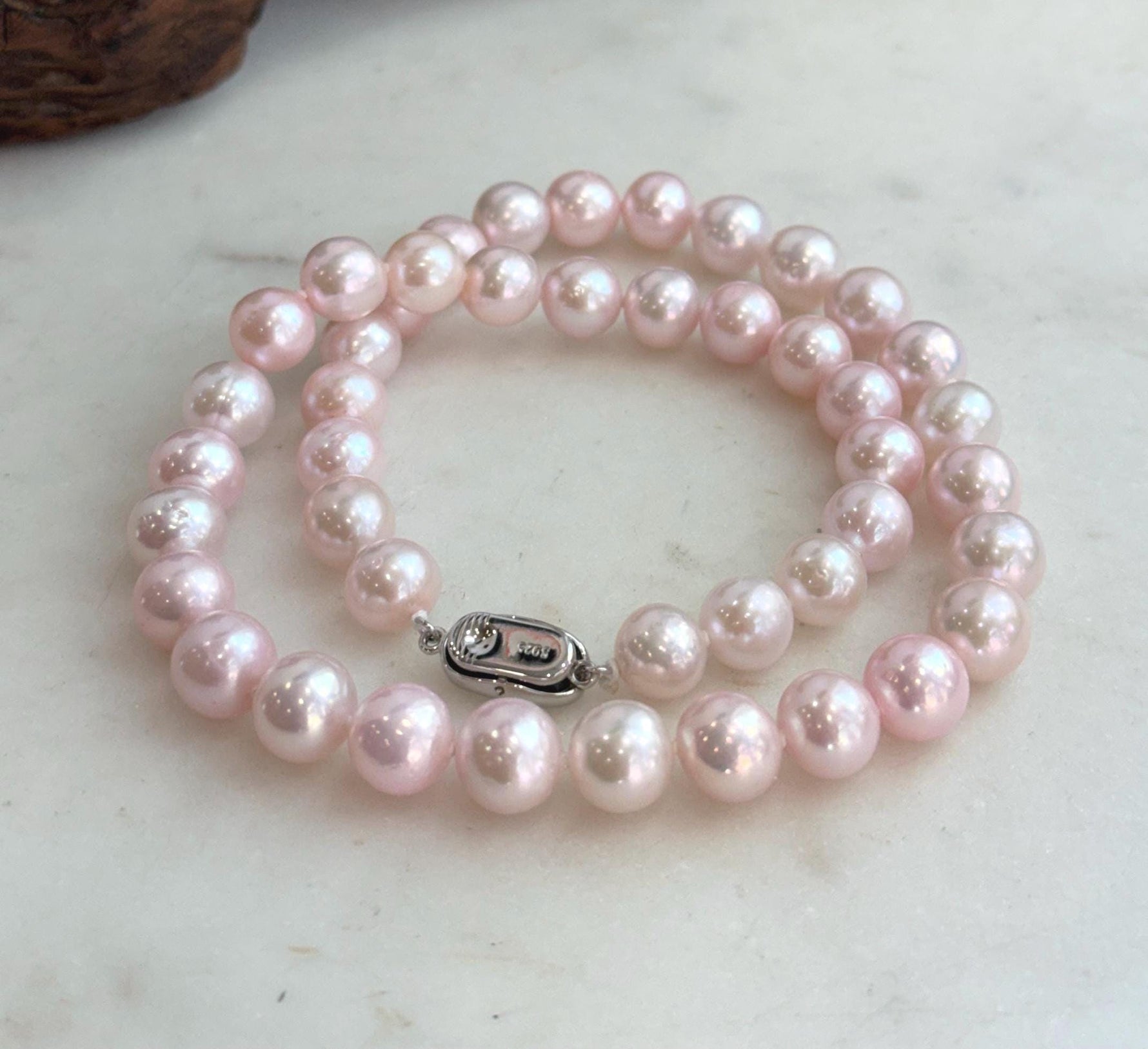 Elegant 17.8-inch pearl necklace hand knotted with 44 luminous freshwater pearls.