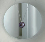 Close-up of 11mm Edison purple pearl with extreme mirror luster, accented by a sparkling natural diamond.