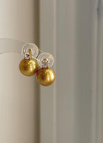 Elegant golden freshwater pearl stud earrings with large 11.3mm Edison pearls and sterling silver settings.