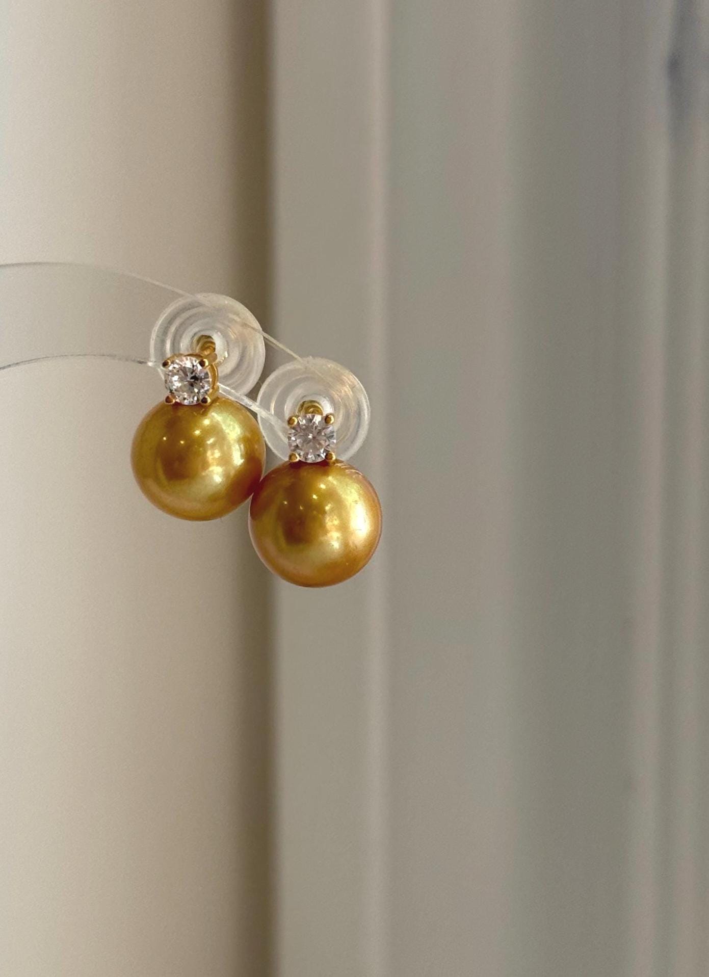 Elegant golden freshwater pearl stud earrings with large 11.3mm Edison pearls and sterling silver settings.