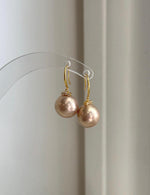 Genuine freshwater Edison pearl earrings featuring elegant rose champagne golden tones.