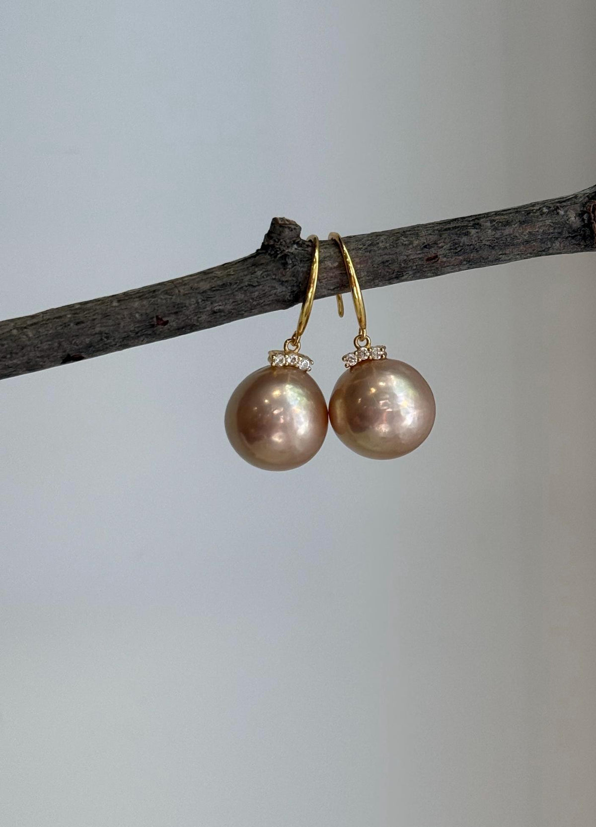 Rose champagne gold Edison pearl earrings with elegant minimalist hook design.