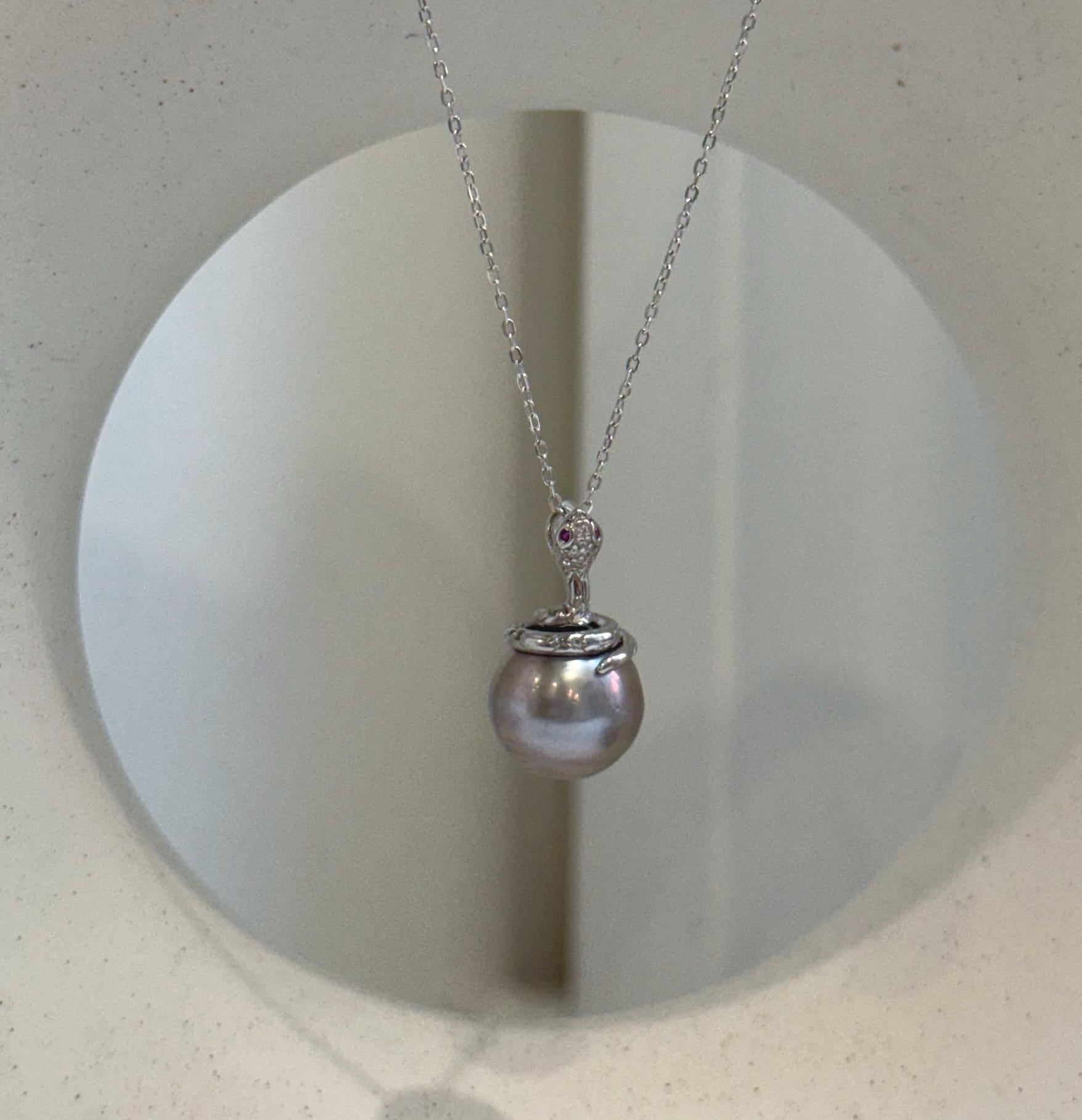 Tahitian platinum pearl snake pendant with a round 11.8mm ocean pearl and brilliant reflective luster.