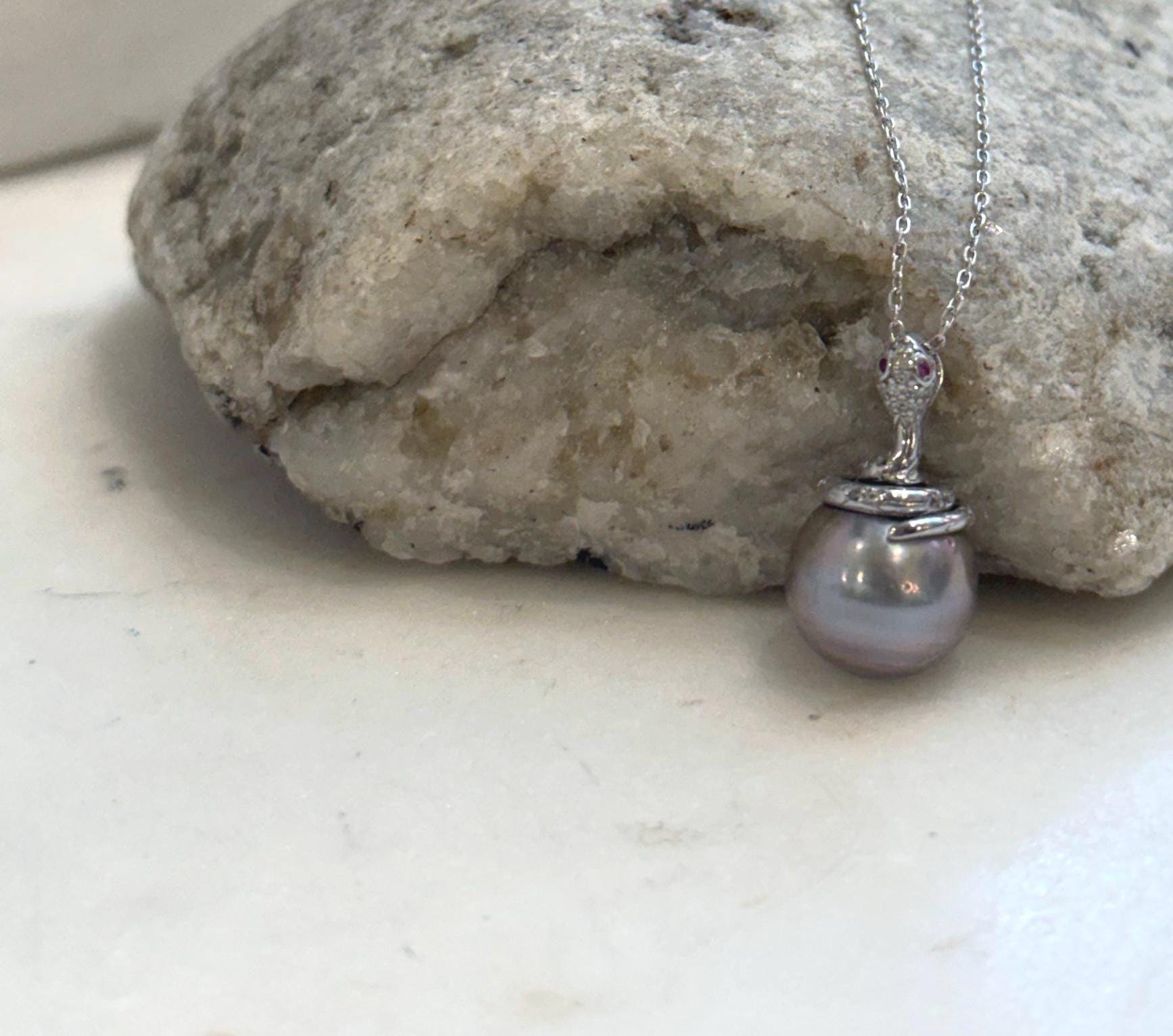 Genuine ocean pearl snake pendant with an 11.8mm Tahitian pearl and polished sterling silver setting.