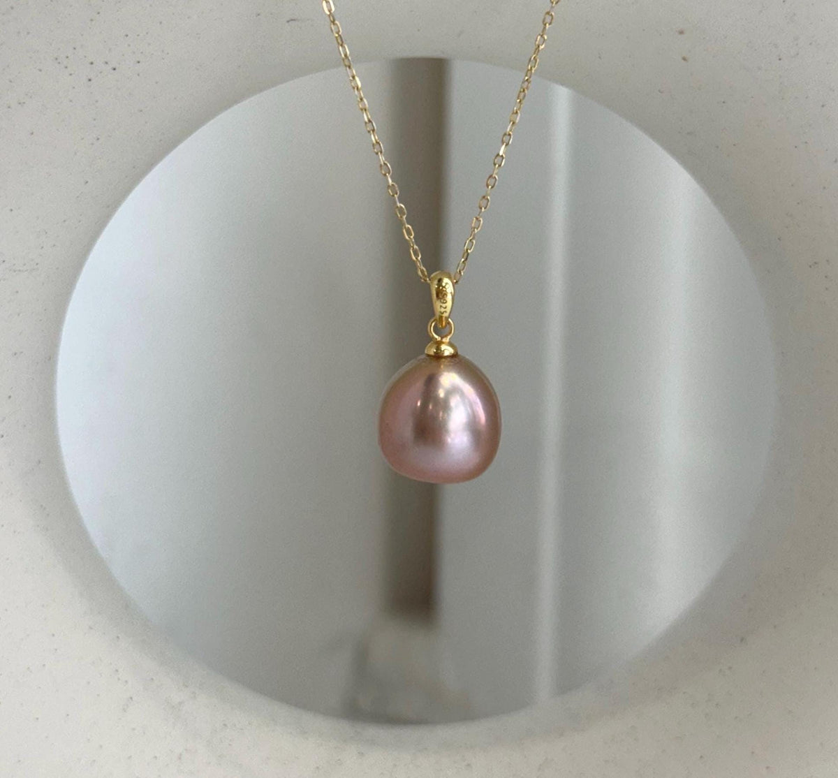 Elly’s 12.1mm Edison rose gold freshwater pearl pendant with extreme mirror luster.