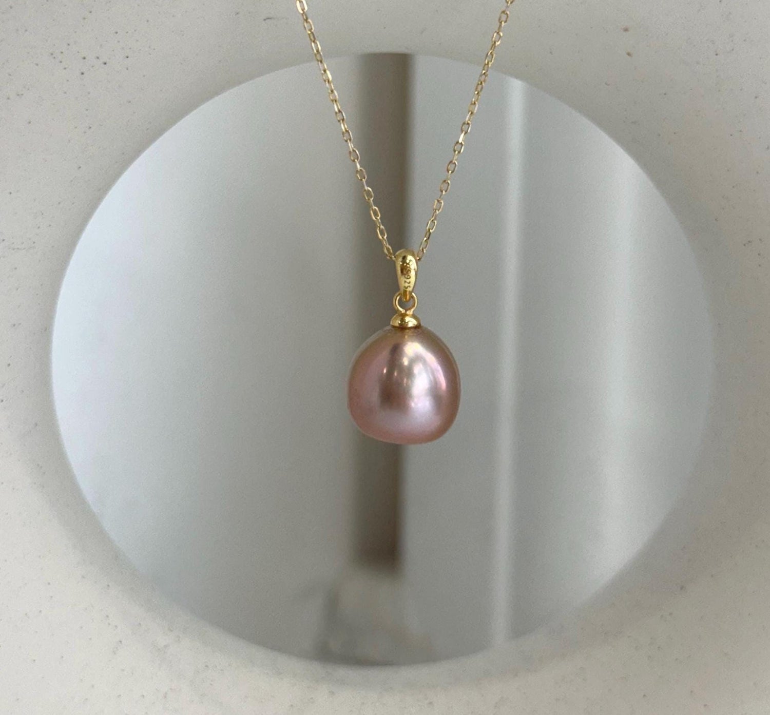 Elly’s 12.1mm Edison rose gold freshwater pearl pendant with extreme mirror luster.