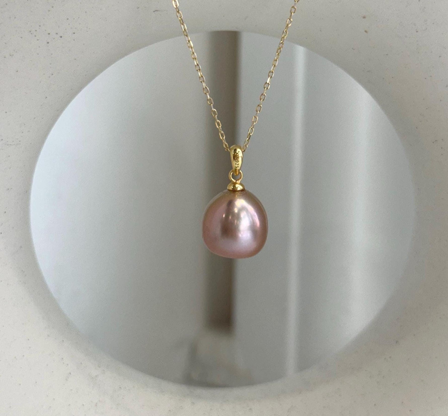 Elly’s 12.1mm Edison rose gold freshwater pearl pendant with extreme mirror luster.