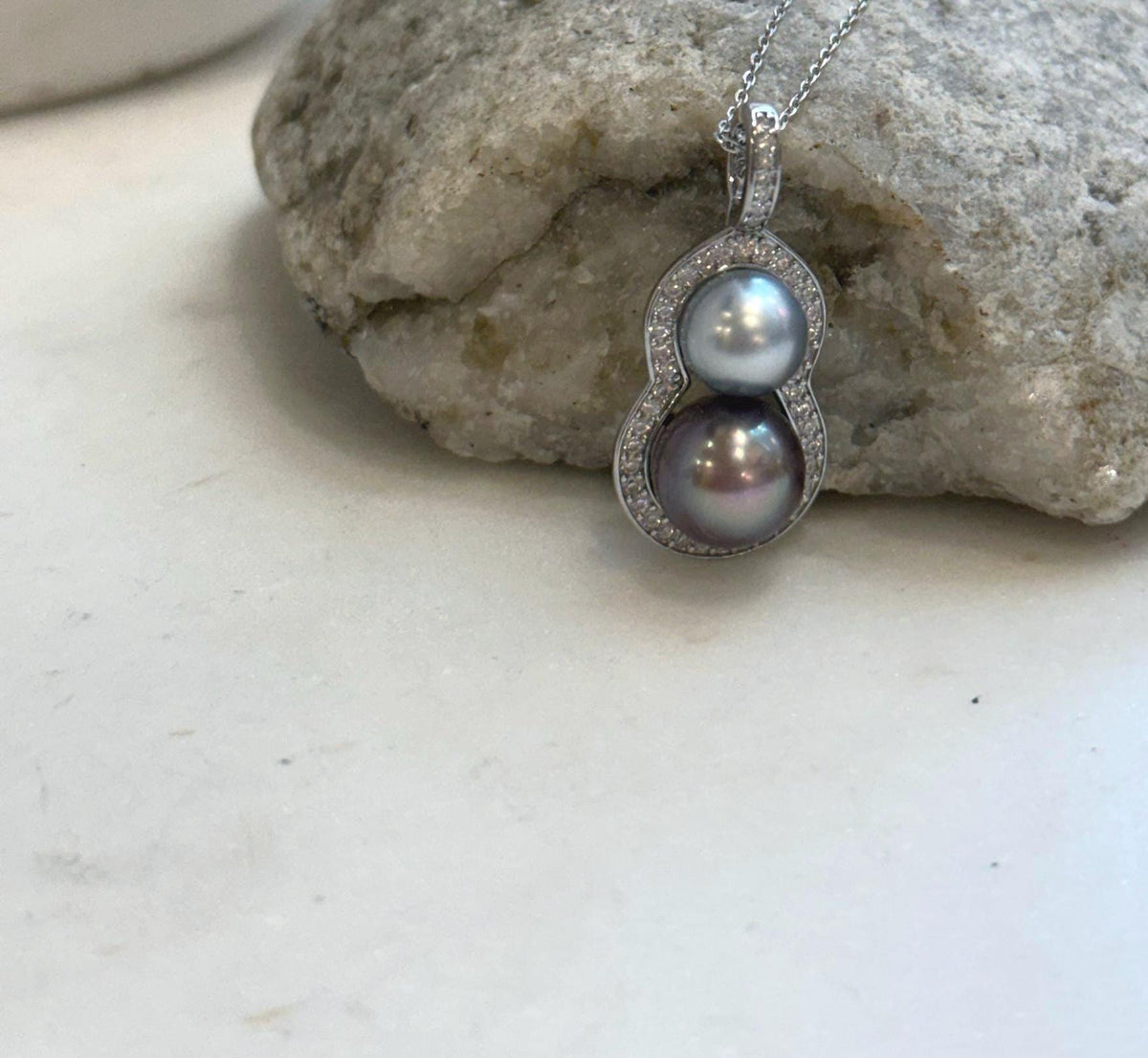 Close-up of two Tahitian pearls arranged in a stylish gourd-shaped pendant design.
