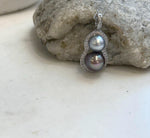Close-up of two Tahitian pearls arranged in a stylish gourd-shaped pendant design.