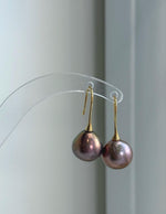 Natural rose gold green Edison pearl earrings featuring intense luster and beautiful metallic reflections.
