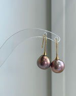 Luxury freshwater pearl hook earrings featuring large 12.6mm Edison pearls and sterling silver settings.