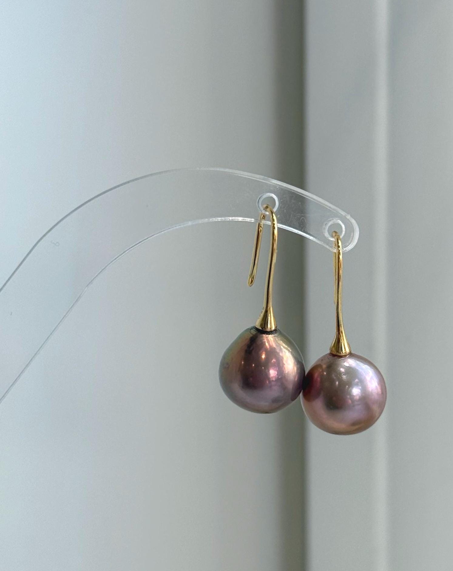Luxury freshwater pearl hook earrings featuring large 12.6mm Edison pearls and sterling silver settings.