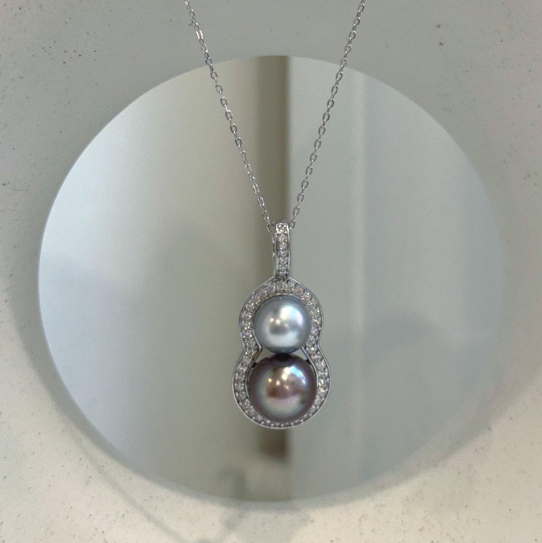 Luxury double Tahitian pearl necklace pendant with a modern gourd-inspired design.