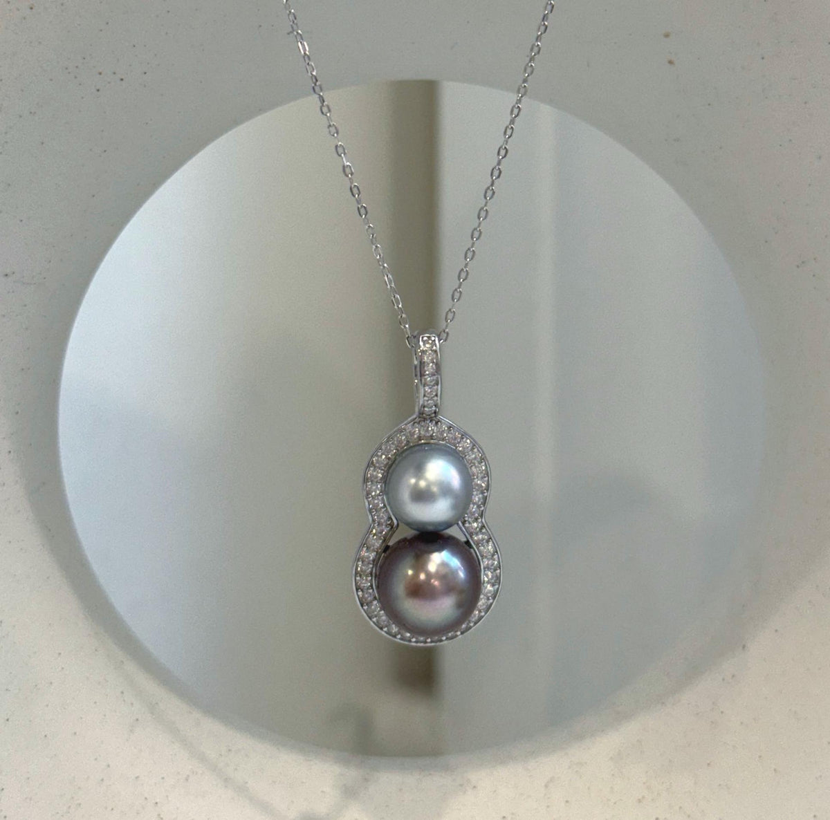 Minimalist S925 sterling silver pendant featuring two lustrous Tahitian ocean pearls.