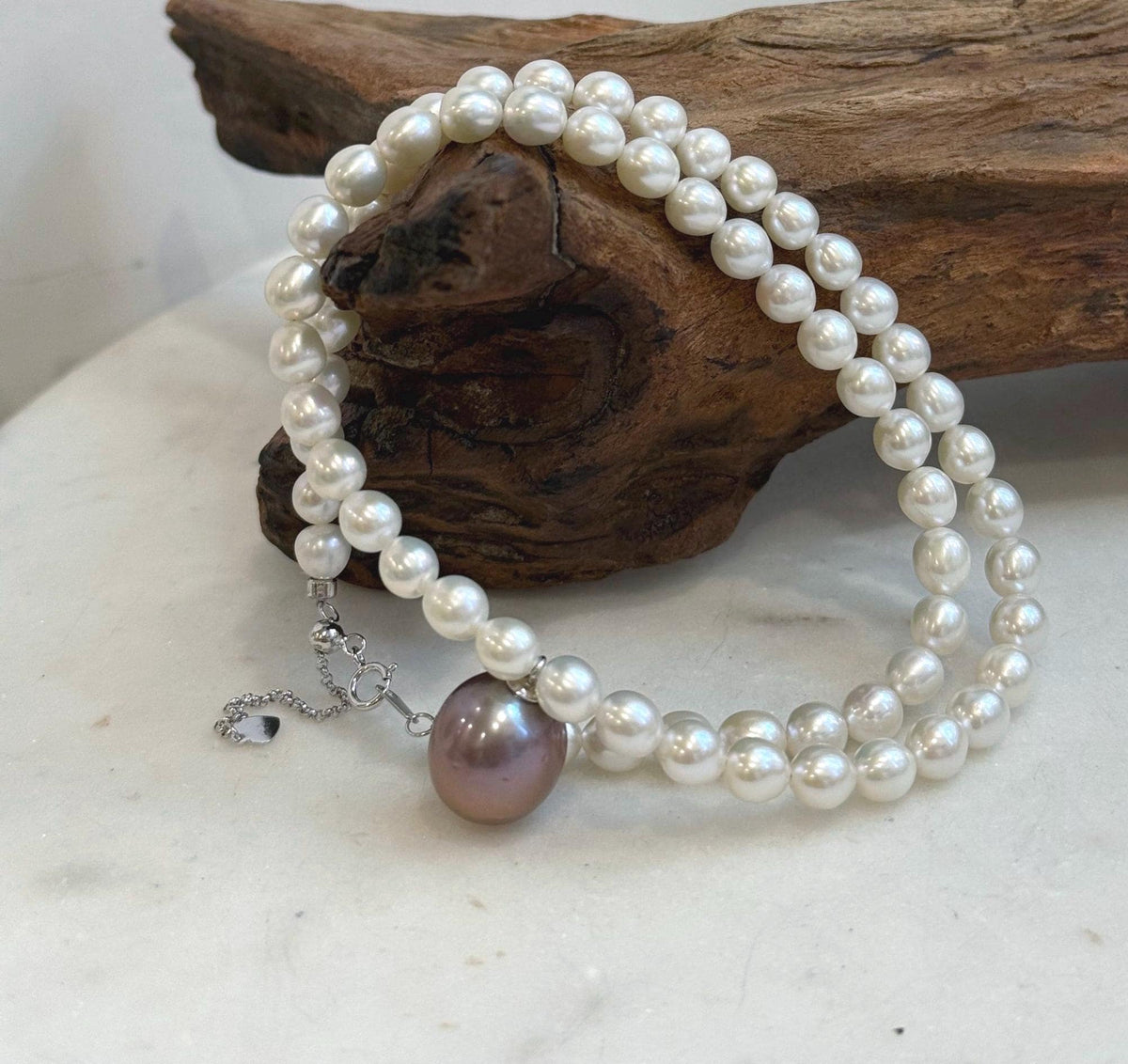 Purple lavender Edison pearl pendant on a classic white freshwater pearl strand.