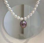 Genuine freshwater pearl necklace with purple Edison pearl pendant.
