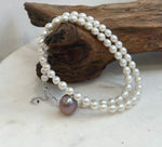 Classic white pearl strand accented with a statement purple Edison pearl.
