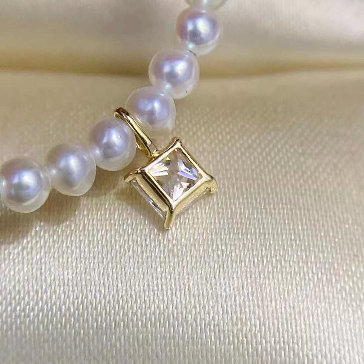 Clear square moissanite jewelry charm featuring a classic princess cut and solid 18K gold setting.