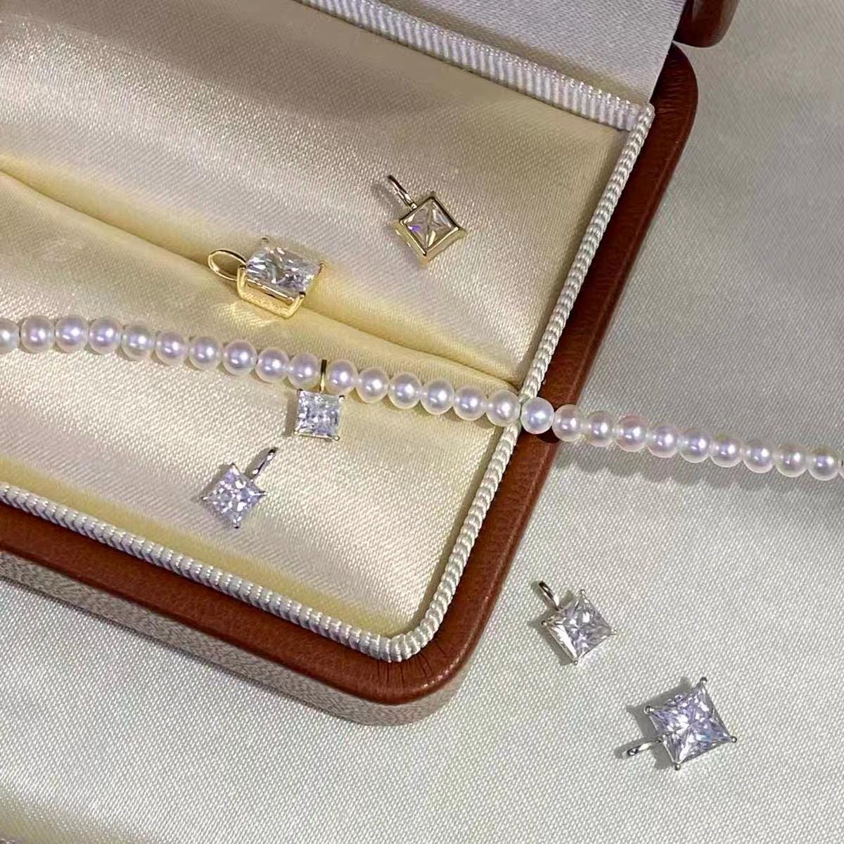 Elegant square moissanite charm with brilliant faceted clear stone and minimalist 18K gold setting.