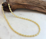 Golden freshwater pearl necklace with 3.5–5.7mm genuine pearls and mirror luster.
