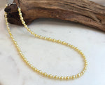 Close-up of 3.5–5.7mm golden freshwater pearls showing beautiful mirror-like luster.