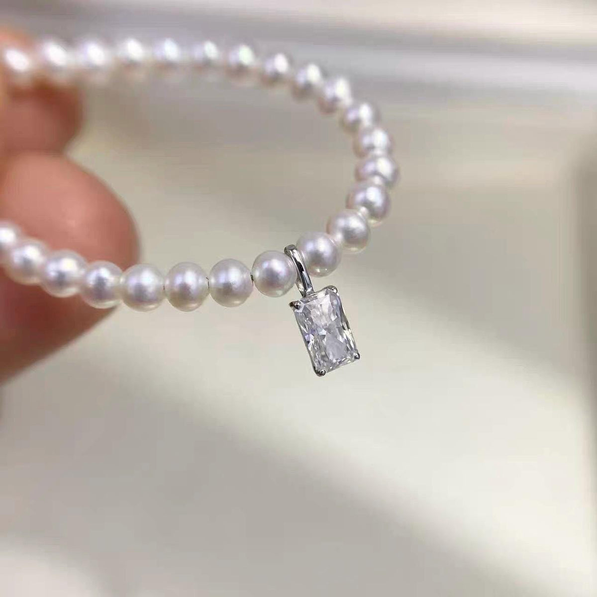 Emerald cut rectangular clear moissanite charm crafted in Au750 solid 18K gold for elegant jewelry making.