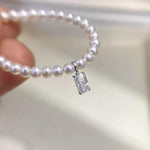Emerald cut rectangular clear moissanite charm crafted in Au750 solid 18K gold for elegant jewelry making.