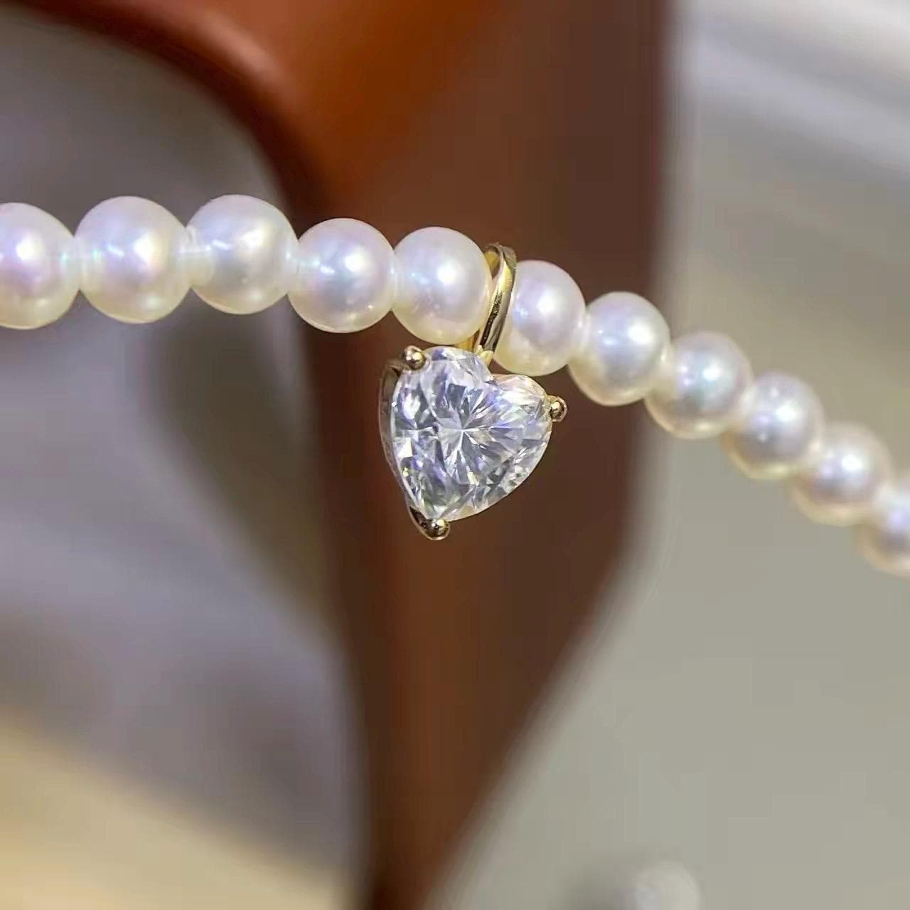 Heart cut clear moissanite charm crafted in Au750 solid 18K gold with brilliant sparkling luster.
