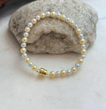 Close-up of 4.3–5.5mm freshwater pearls with beautiful golden silver tones.