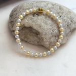 Classic small pearl bracelet with beautiful golden silver color and high luster.