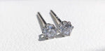 Solid 18K gold moissanite stud earrings featuring sparkling round-cut stones secured in elegant 6-prong settings.