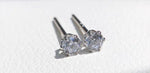 Sparkling clear moissanite stud earrings with round-cut stones and delicate Au750 solid 18K gold 6-prong mounts.