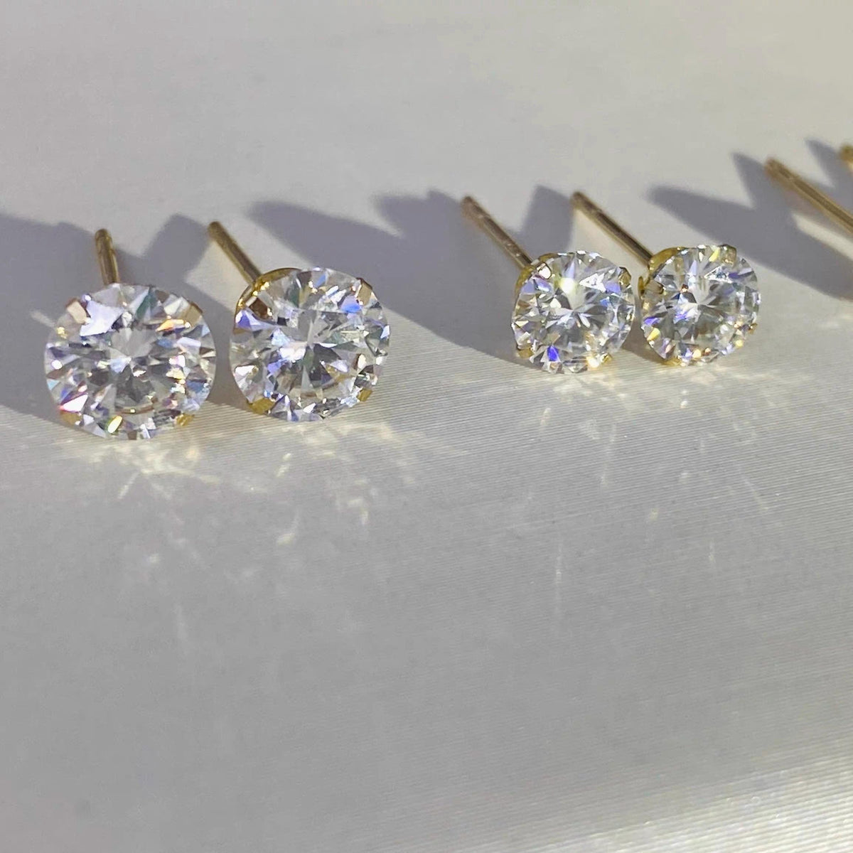 3mm round moissanite stud earrings in solid 14K gold, petite minimalist fine jewelry.
