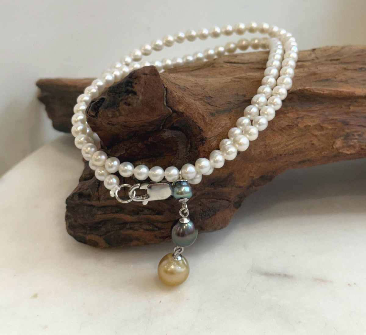 White pearl necklace featuring a 4cm dangling pendant with three colorful genuine pearls.