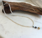 Elegant pearl necklace set with white freshwater pearls and Tahitian and South Sea pearl accents.