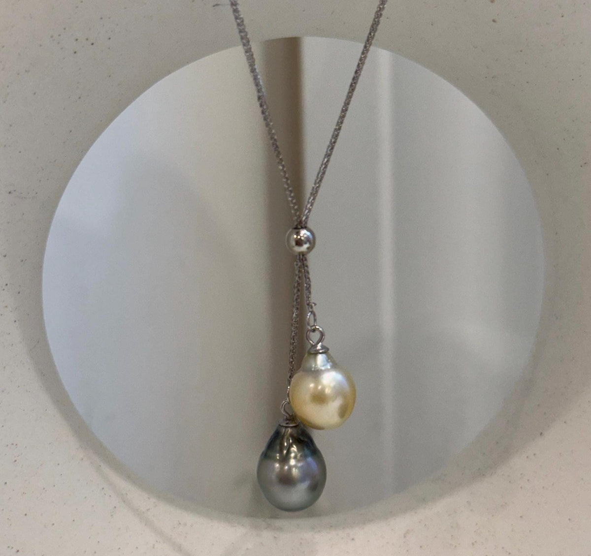 Double pearl pendant featuring 9.1–9.7mm South Sea golden and Tahitian ocean pearls with extreme mirror luster.