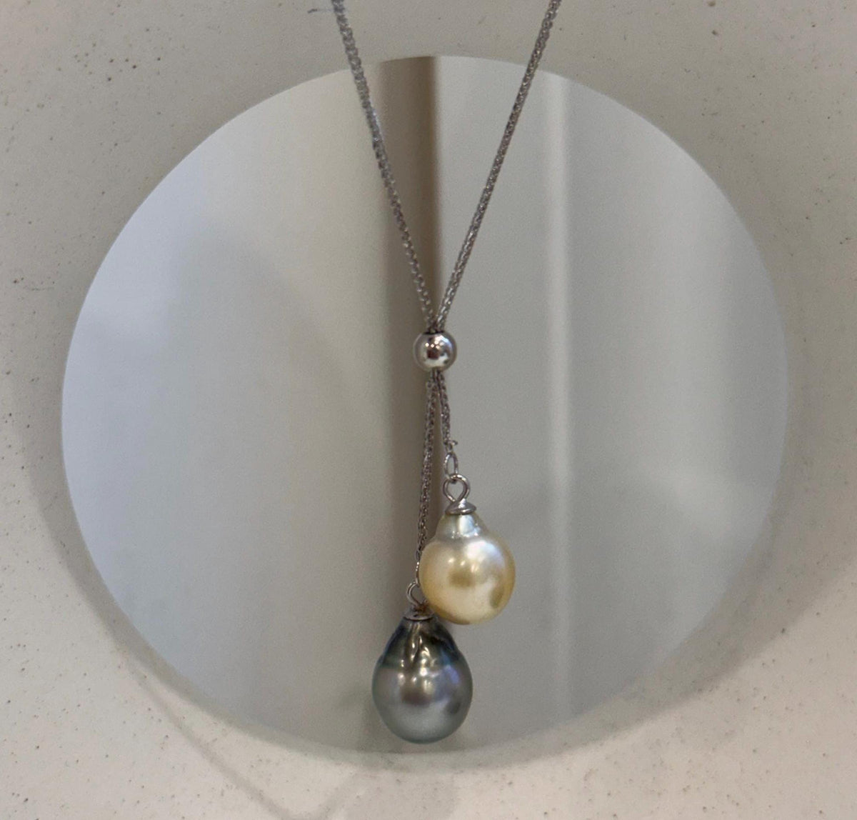 Elegant two pearl pendant chain set with contrasting golden and dark Tahitian saltwater ocean pearls.