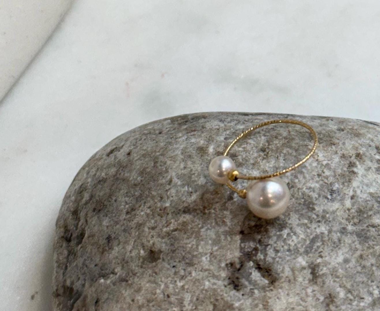 Luxury 18K gold pearl ring showcasing a lustrous Japanese Akoya saltwater pearl in a delicate adjustable engagement ring design.