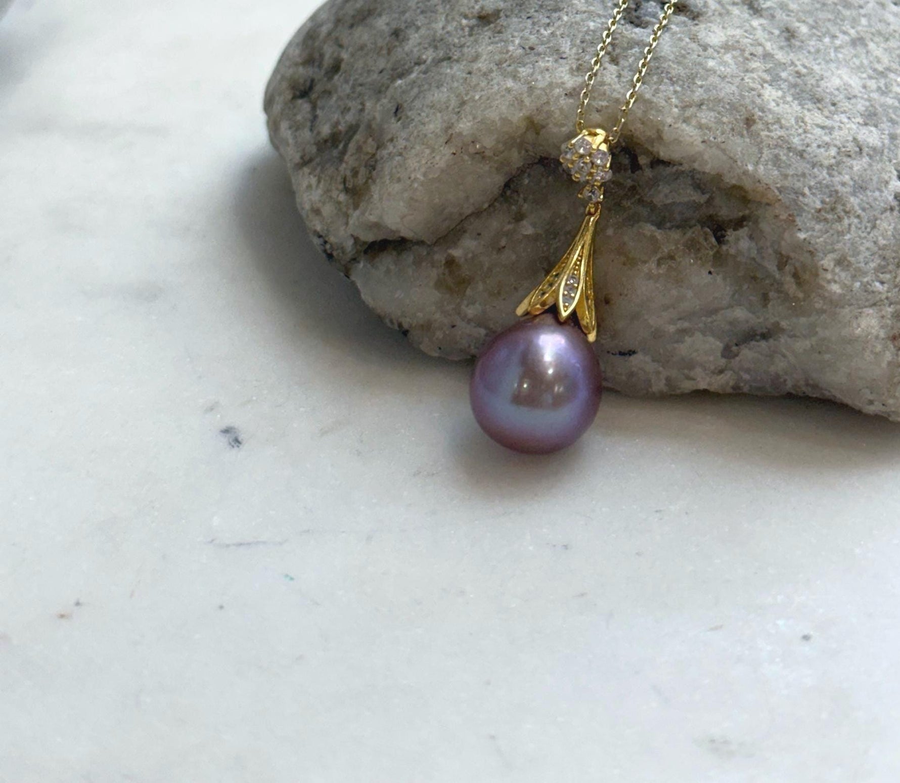 Natural freshwater Edison pearl pendant featuring rich lavender purple iridescence