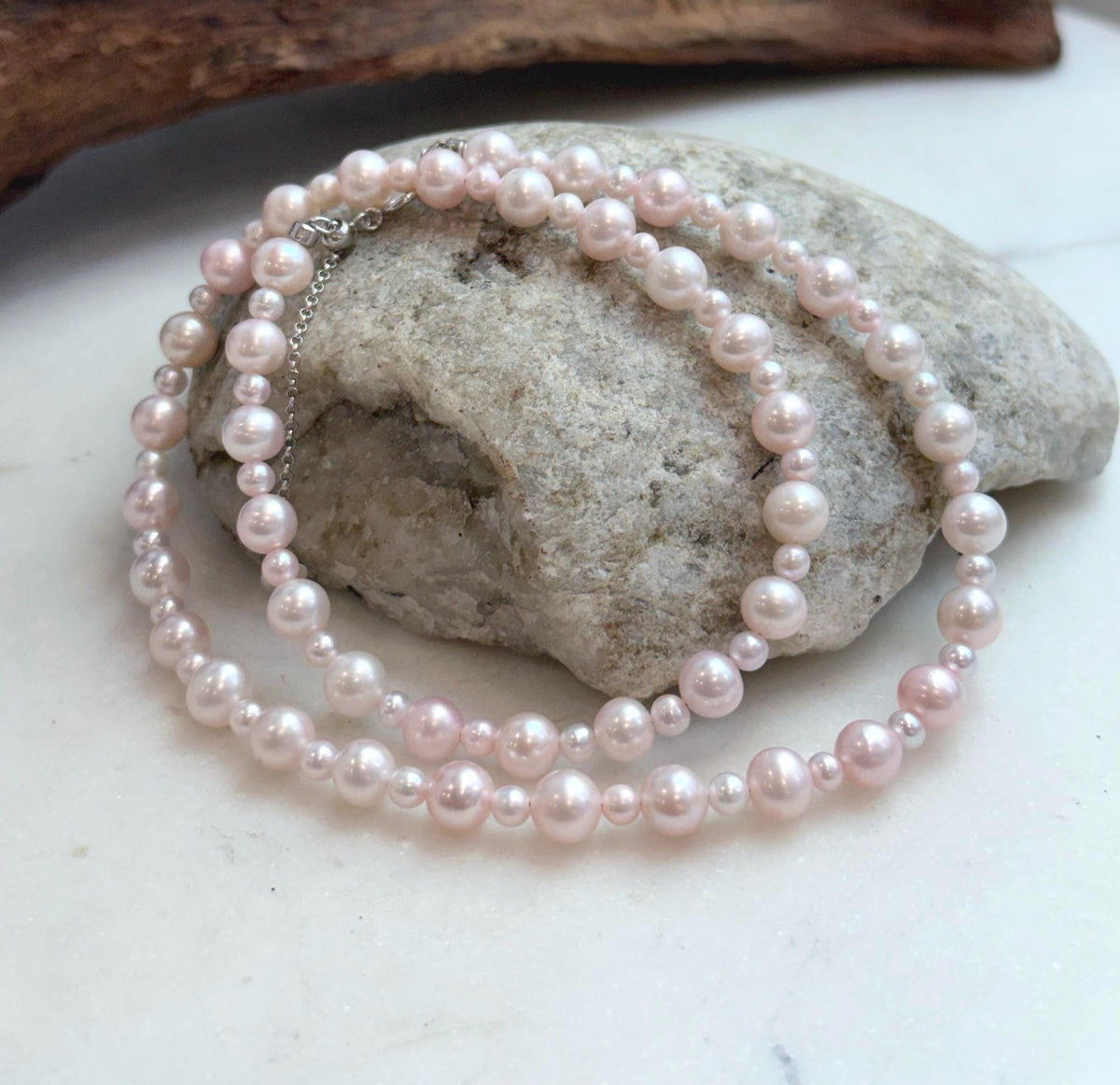 Elegant pale pink pearl jewelry featuring genuine freshwater pearls with smooth, luminous surfaces.